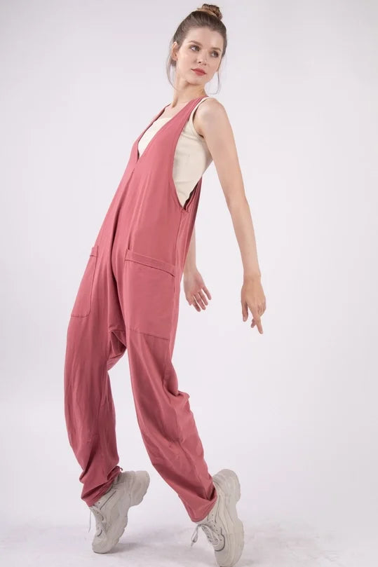 Woman wearing a pink jumpsuit on a white background